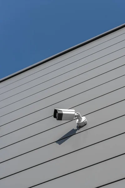 CCTV Security camera on building wall geometric linear grey sunny silver — 스톡 사진