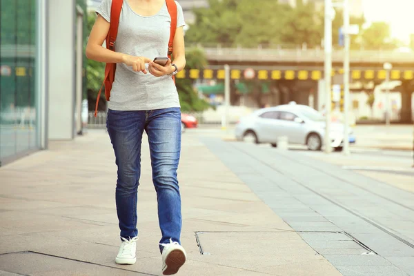 Kvinnan promenader med smart telefon — Stockfoto