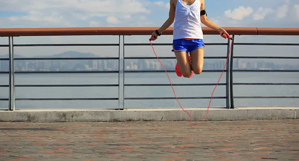 young fitness woman skipping rope