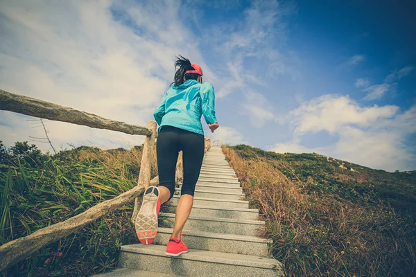 Woman running on mountain stairs — Stock Photo, Image