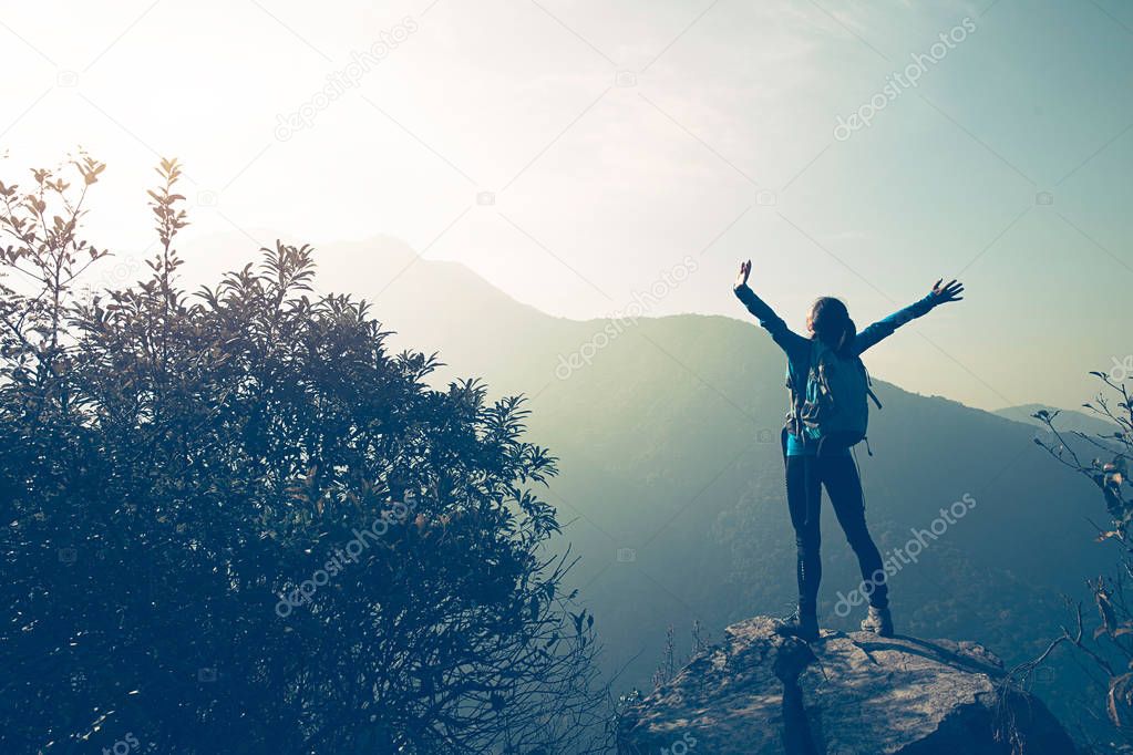 young traveler with raised hands