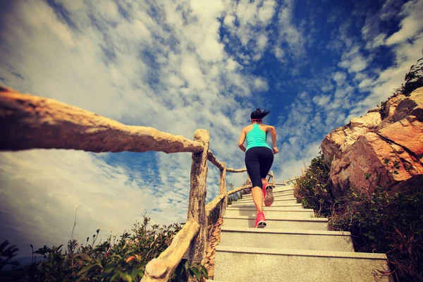 Woman running on mountain stairs — Stock Photo, Image