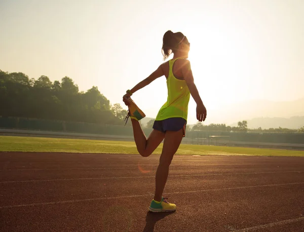 Jonge vrouw stretching benen — Stockfoto