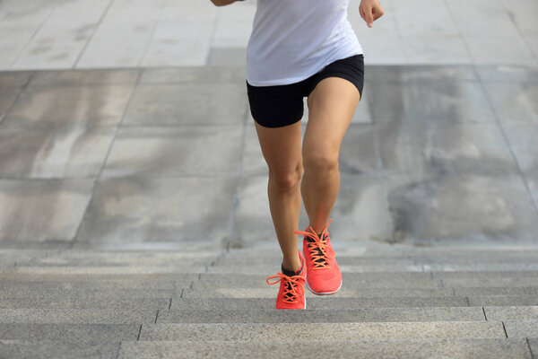young sport woman running upstairs