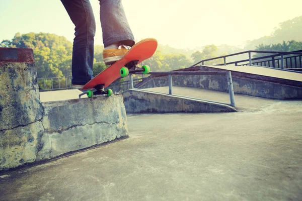 skateboarder legs riding skateboard