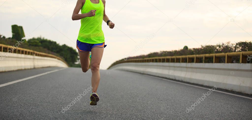 young woman running on road