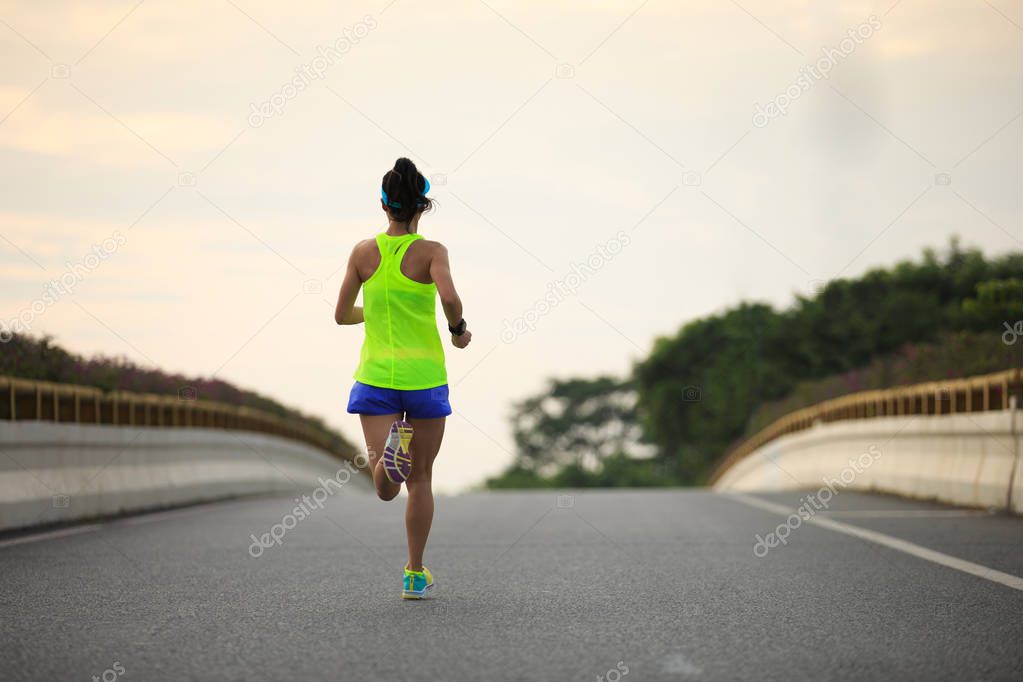 young woman running on road