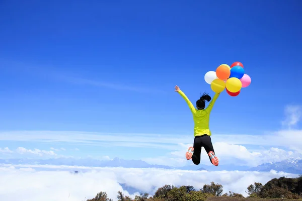 Young woman with colorful balloons — Stock Photo, Image