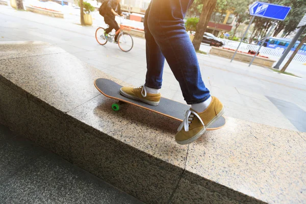 Skateboarder legs riding skateboard — Stock Photo, Image