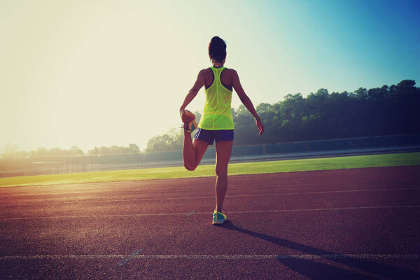 young fitness woman stretching legs 