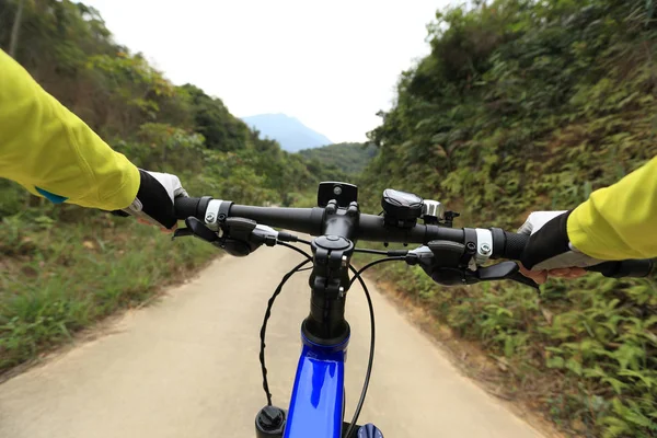 cyclist hands riding mountain bike