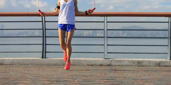 young woman jumping rope 