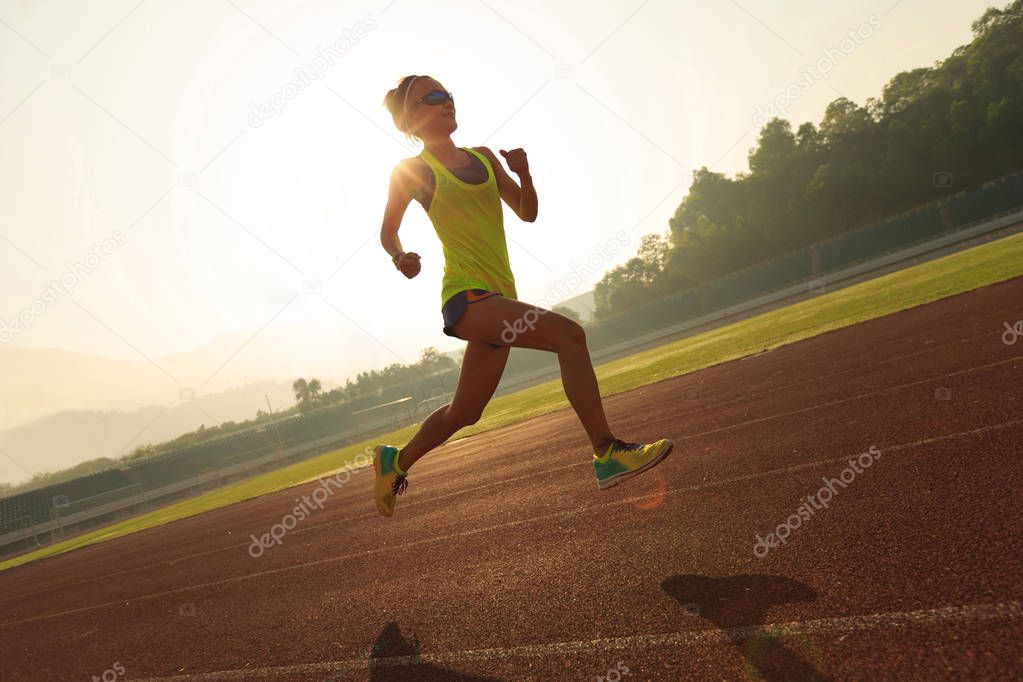 woman running on stadium track