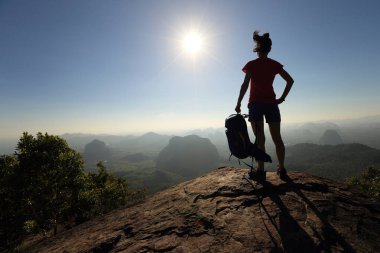dağ tepe üzerinde sırt çantası olan kadın