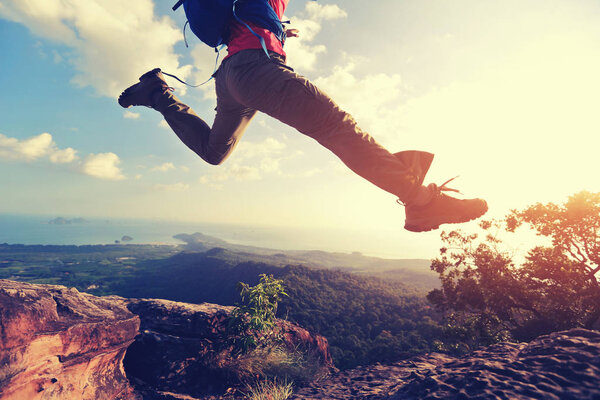 jumping over precipice between two rocky mountains
