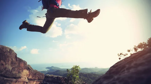 Ung kvinna hoppa över stupet — Stockfoto