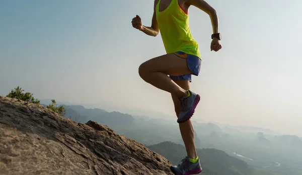 Mujer joven corriendo en la cima de la montaña — Foto de Stock