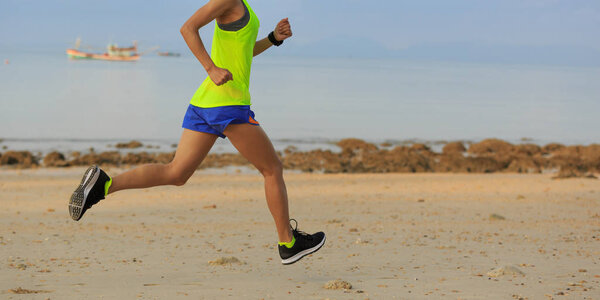  young woman running on beach
