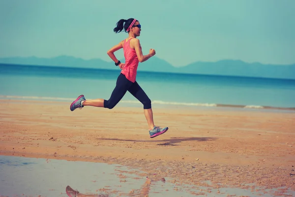 Kumsalda çalıştıran sportif genç kadın — Stok fotoğraf