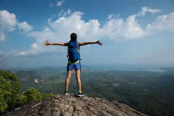 Young woman with raised hands