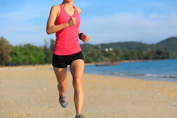 Young woman running at sandy beach — Stock Photo, Image