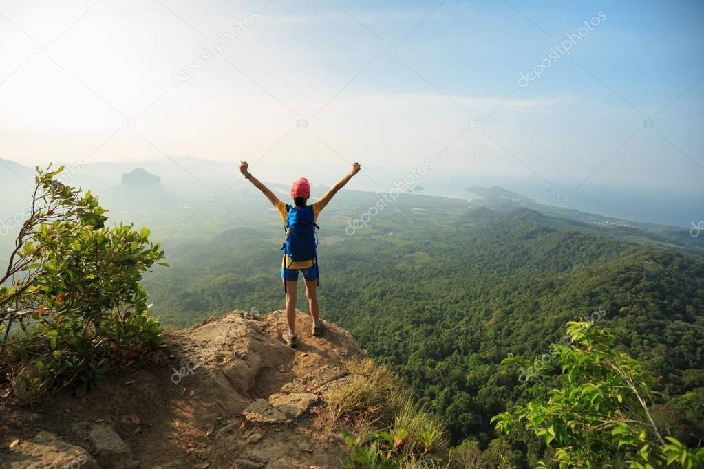 young woman standing with open arms