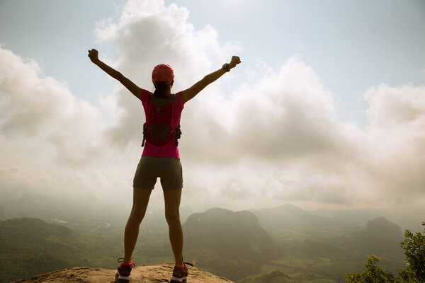 young woman hiker with open arms