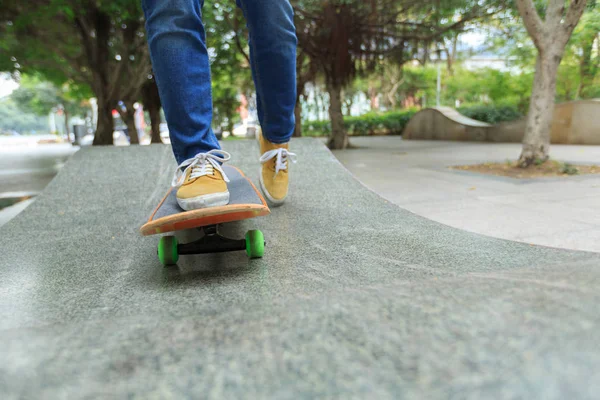 Skateboardåkare ben tränar på skatepark — Stockfoto