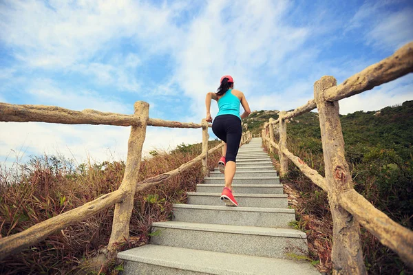 Young woman running on stairs — Stock Photo, Image
