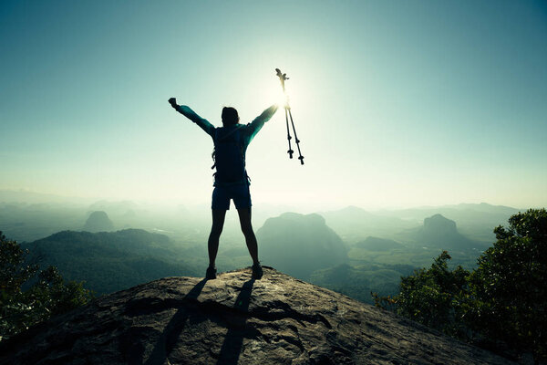 Young woman hiker with open arms