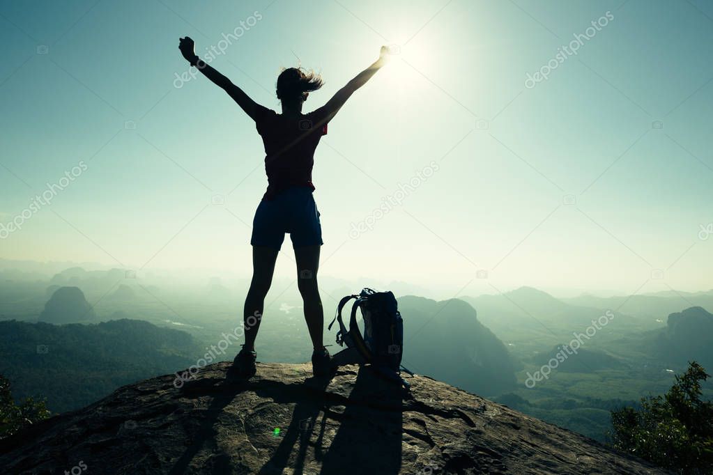 Young woman hiker with open arms