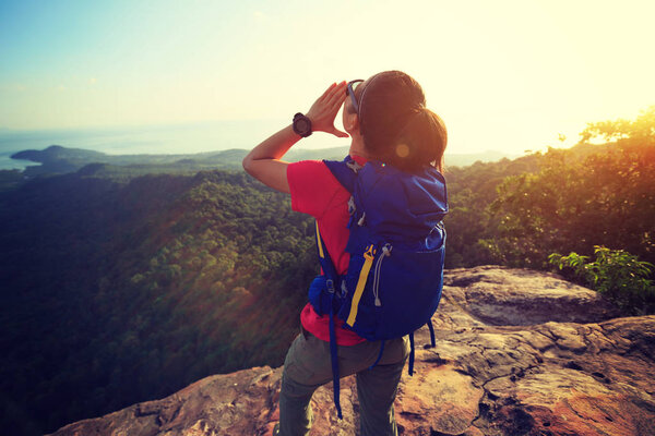 woman shouting on mountain peak