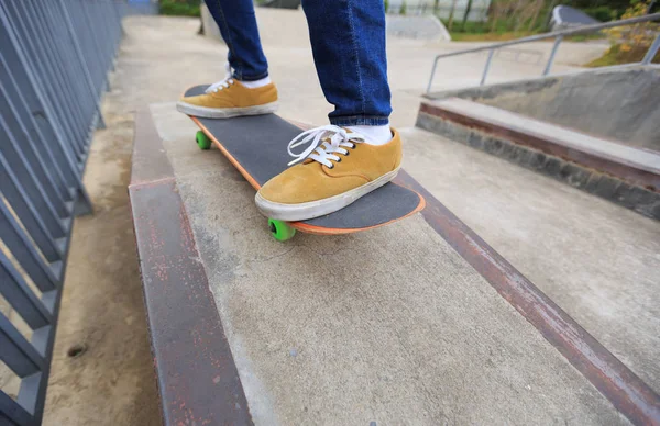 Skateboarder riding at skatepark ramp — стоковое фото