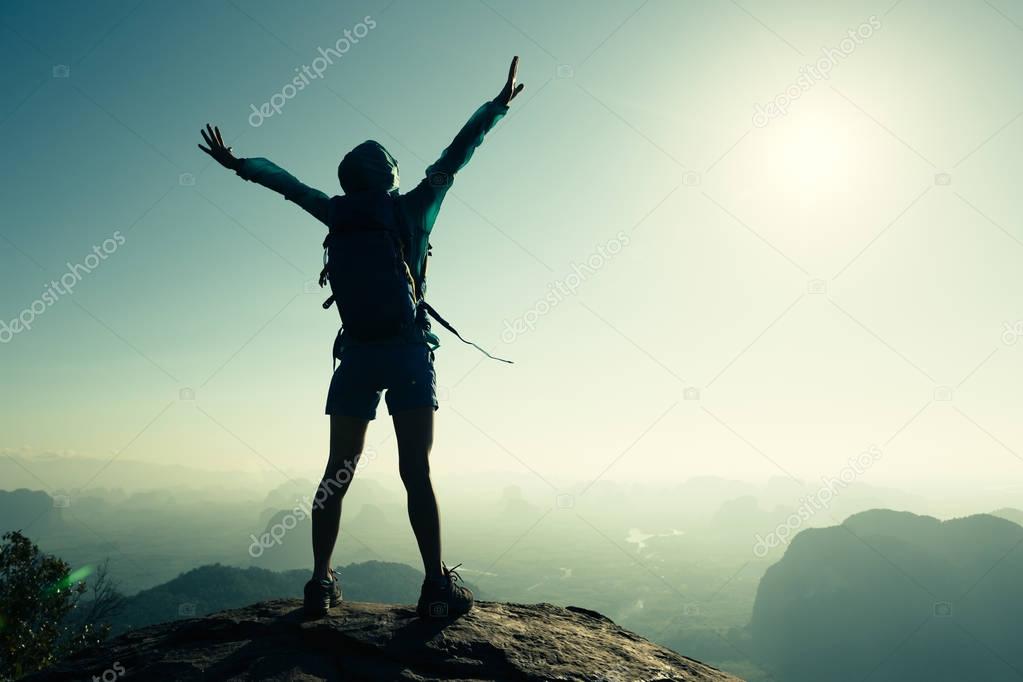 woman hiker standing with open arms