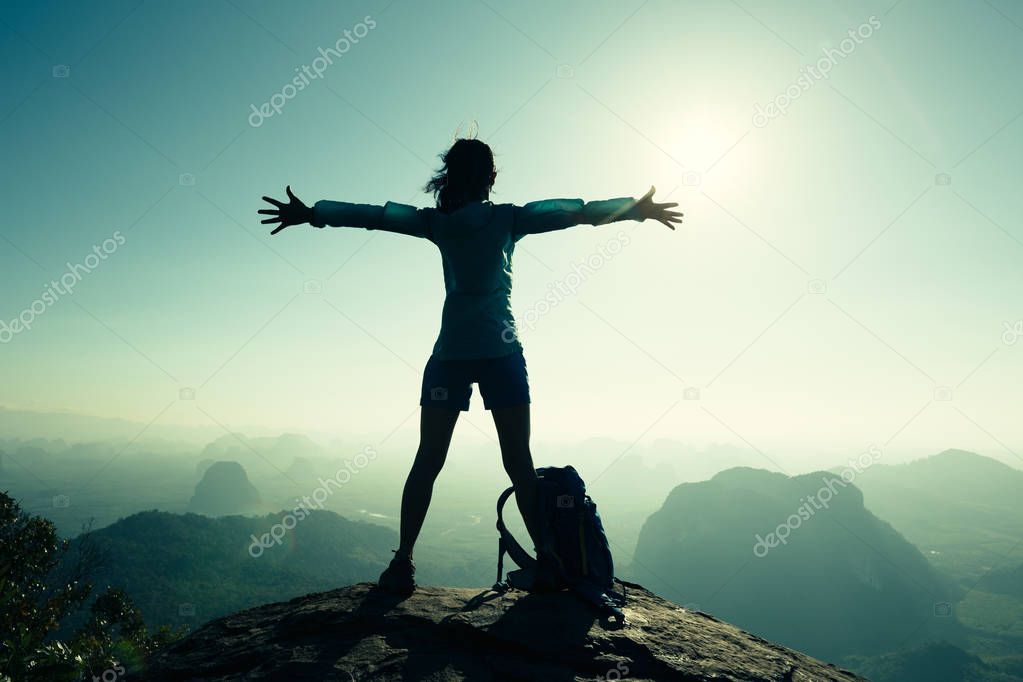 woman hiker standing with open arms