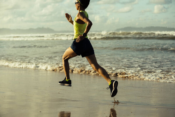 young woman running on beach