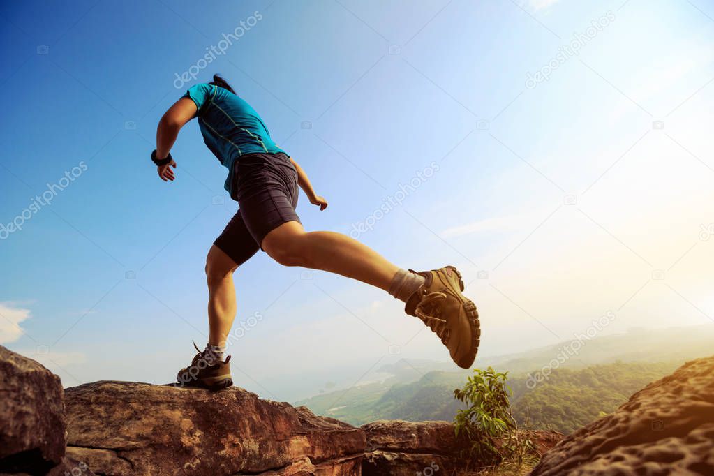Young woman running on mountain 