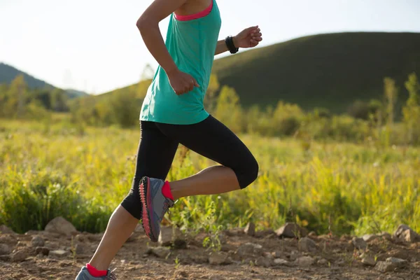 Young woman running on forest trail