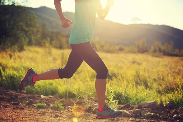 Young woman running on road — Stock Photo, Image