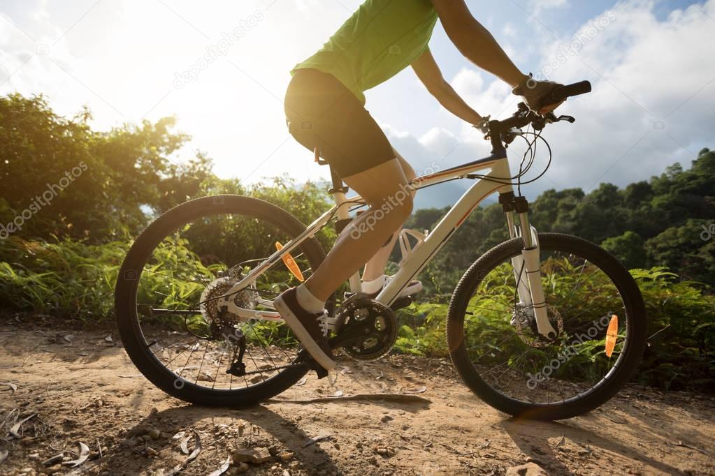 Young woman cycling on trail