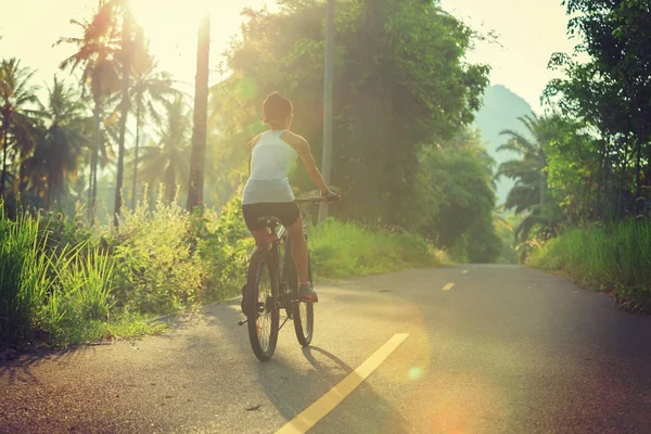 Young  woman cycling on trail