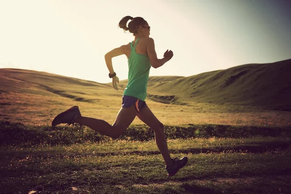 Mujer joven corriendo en pastizales —  Fotos de Stock