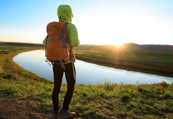 Young woman on riverside hill top — Stock Photo, Image