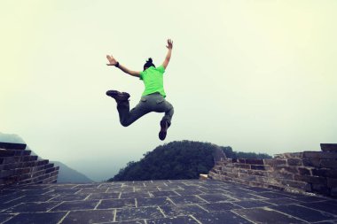 Çin Seddi üzerinde atlama genç kadın uzun yürüyüşe çıkan kimse