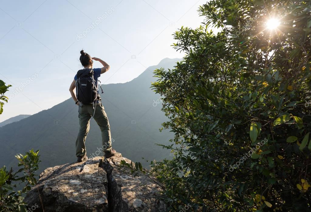 young woman on edge of cliff