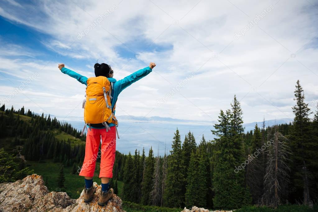 woman backpacker with open arms