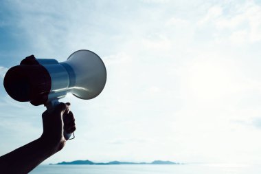 elini tut megafon deniz gökyüzü arka plan altında karşı