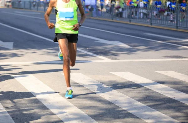 市道を走るマラソンランナーの足 — ストック写真