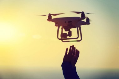 uçan bir dron hangi alarak fotoğraf gündoğumu Denizi üzerinden ulaşan eller silüeti