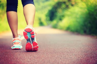 Genç fitness kadın runner bacaklar orman iz üstünde koşmak için hazır